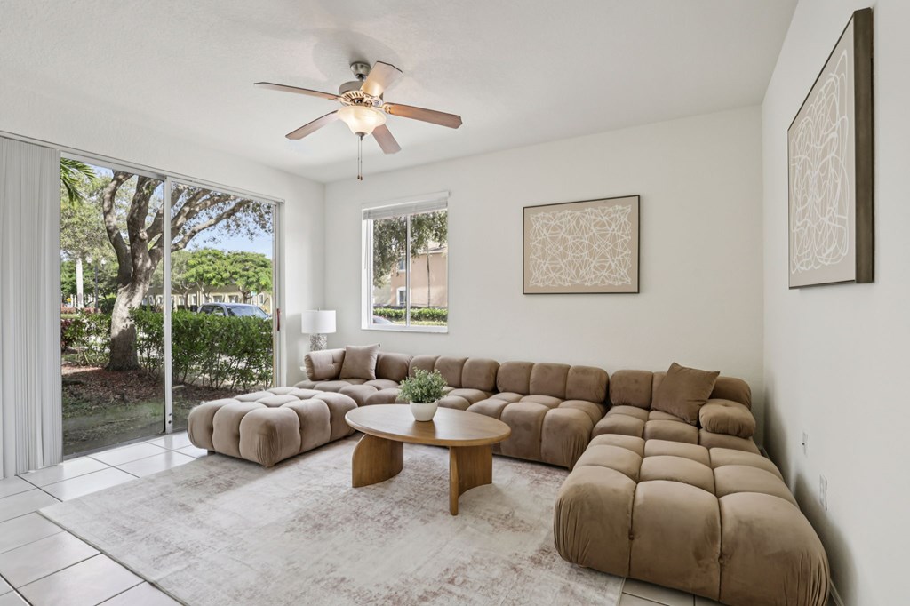 A living room with a large sectional sofa and a coffee table.