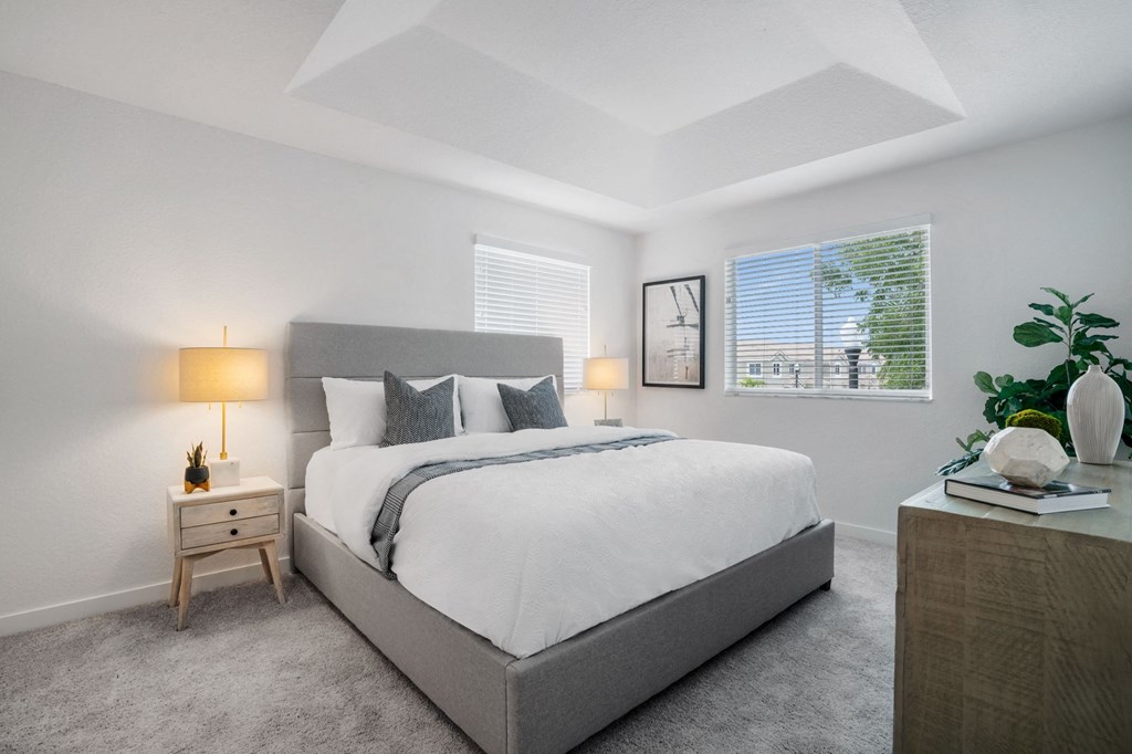 a bedroom with a large bed and a window