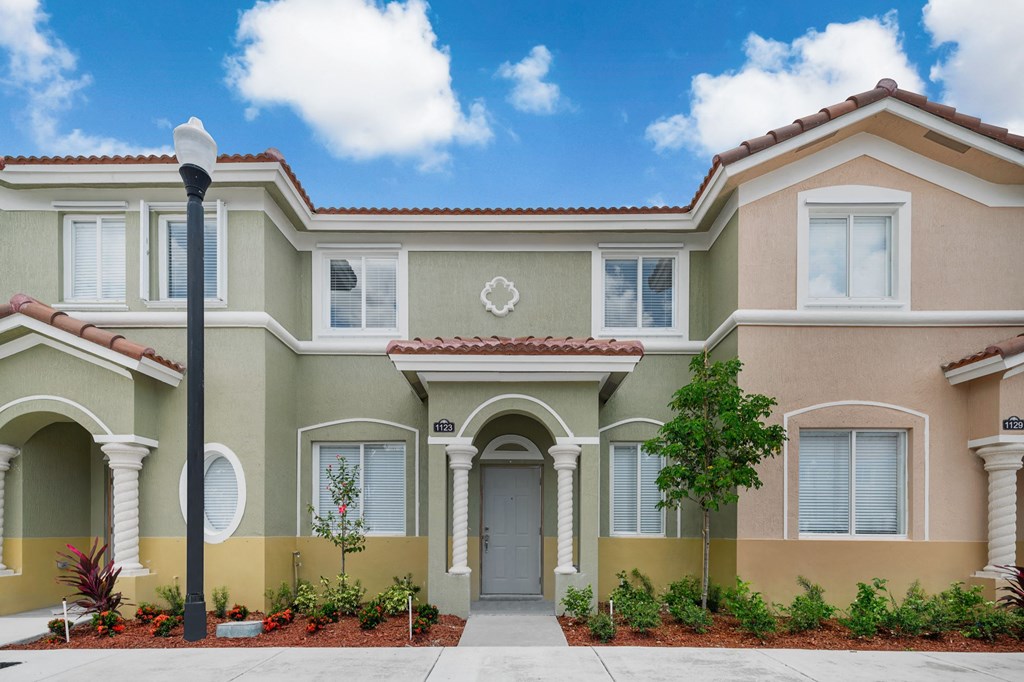 a large house with a sidewalk in front of it