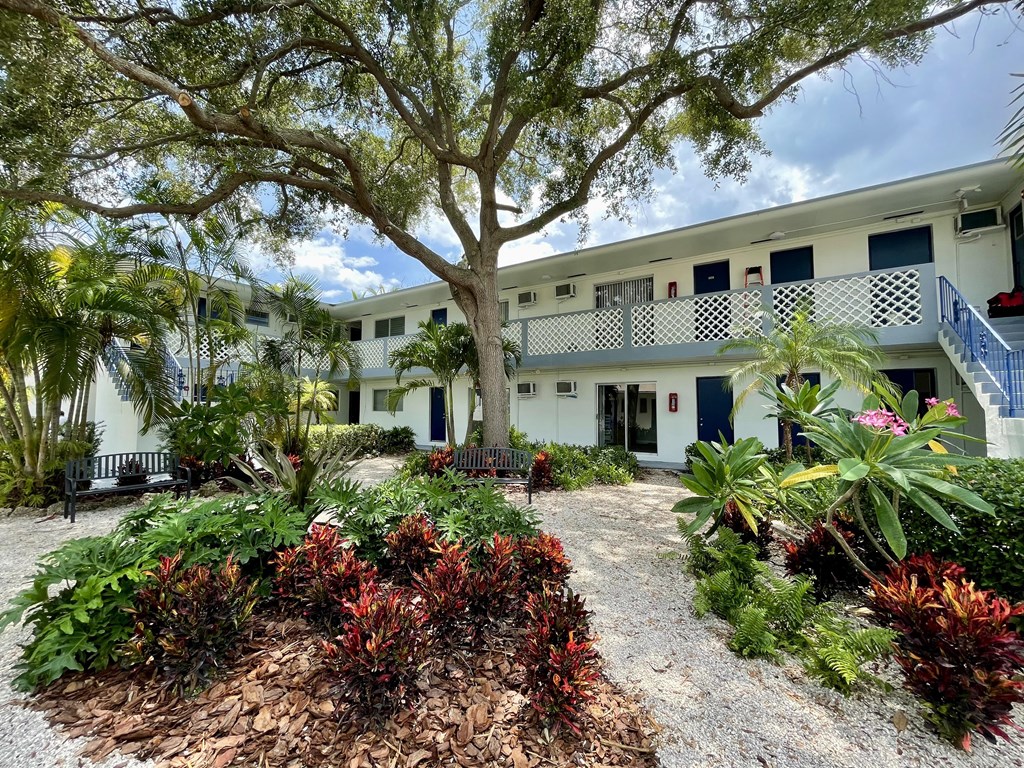 a building with a large tree in front of it at Lakeside @ Biscayne Gardens,North Miami, FL