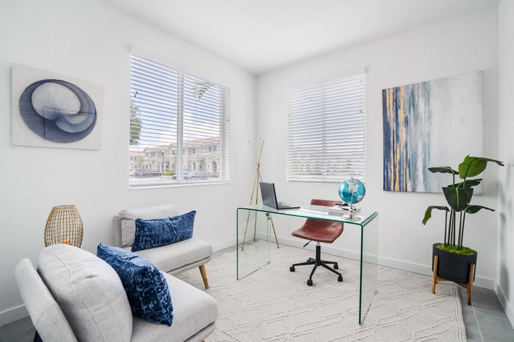 a home office with white walls and a glass desk