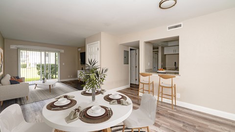A dining room with a white table set for six.