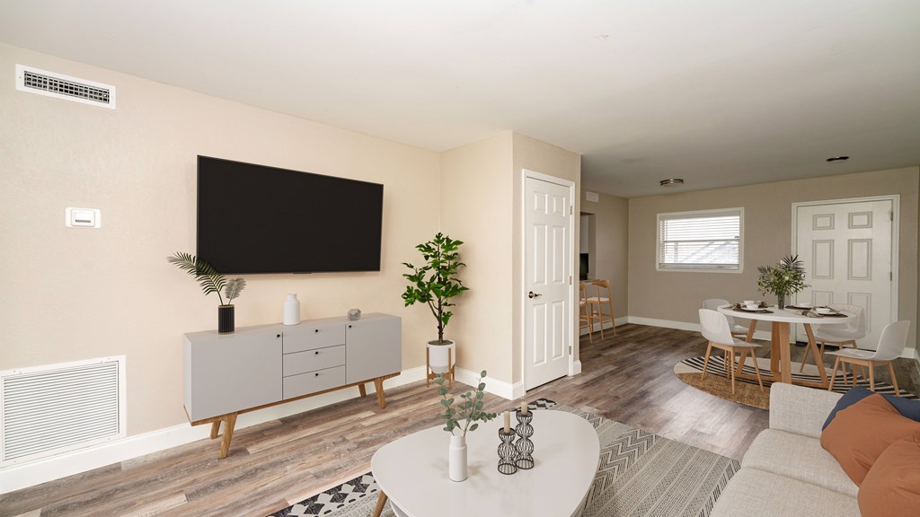 A living room with a white coffee table and a grey cabinet.