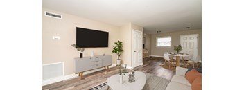 A living room with a white coffee table and a grey cabinet.