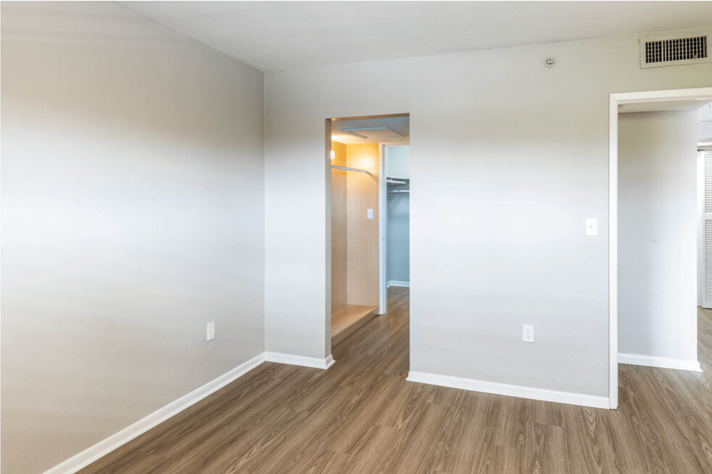 a bedroom with hardwood floors and white walls a bedroom with hardwood floors and white walls at Lakeside @ Biscayne Gardens,North Miami, Florida,33181