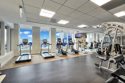 A well-equipped gym with treadmills, exercise bikes, and weight machines.