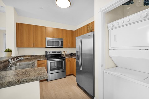 A kitchen with a white oven and a silver refrigerator.