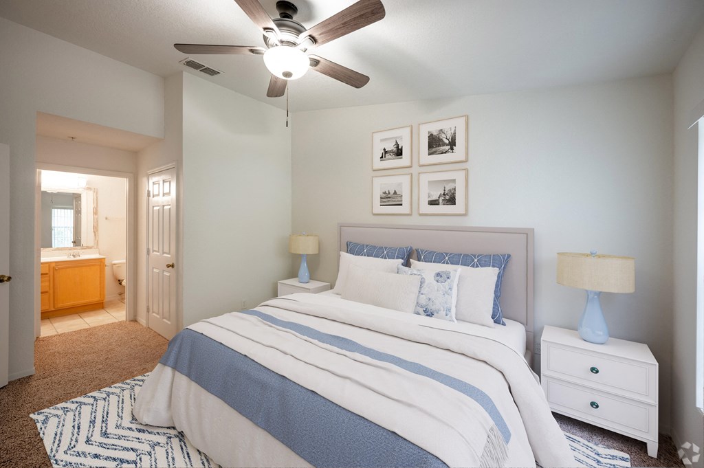 a bedroom with a bed and a ceiling fan