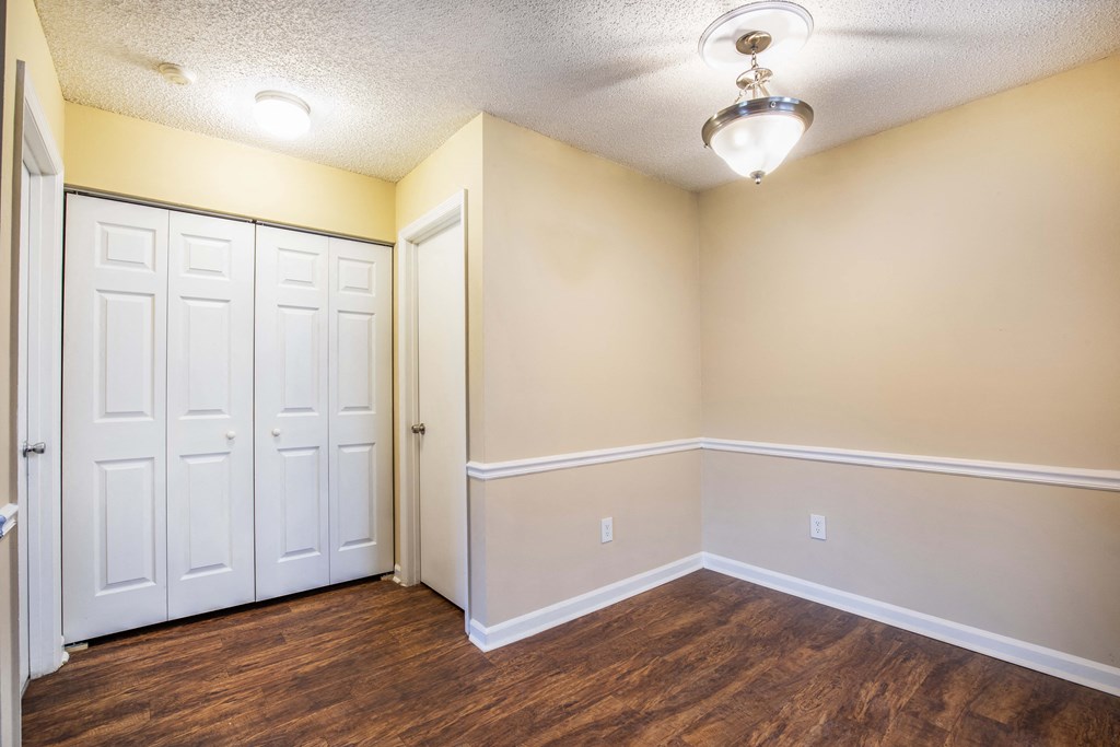 a bedroom with two closets and a door at Lakeside Gardens, Florida