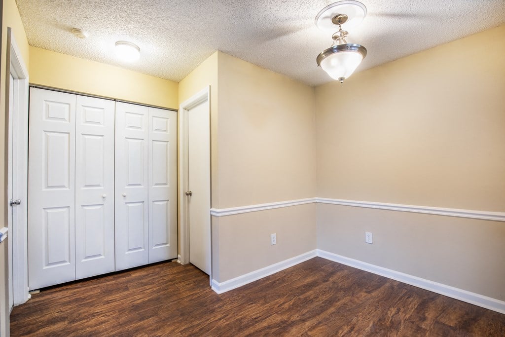 a bedroom with two closets and a door at Lakeside Gardens, Daytona Florida