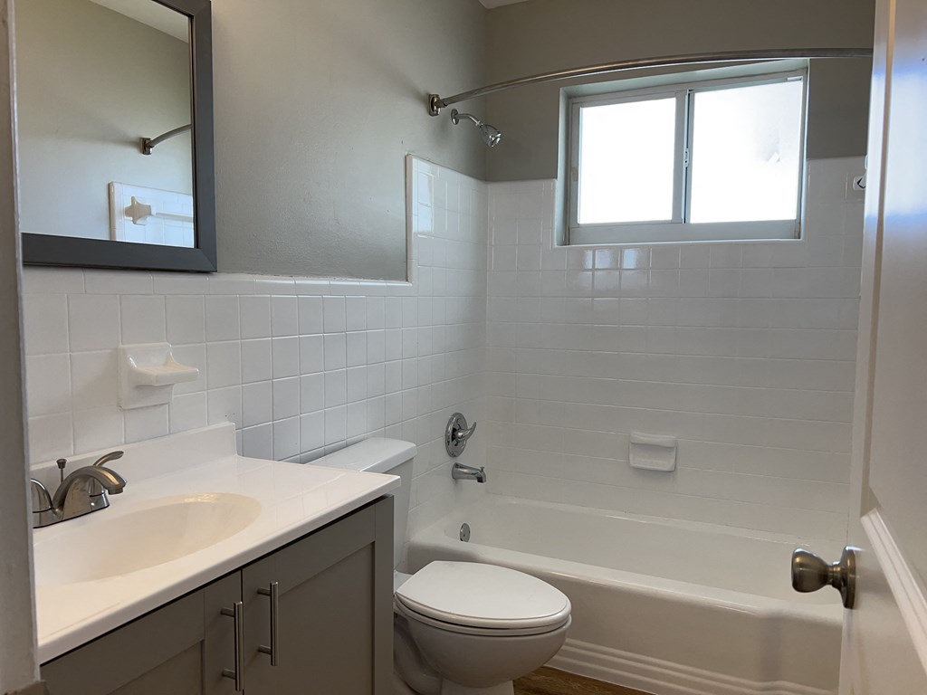 an empty bathroom with a sink toilet and tub  at Palm Gardens @ Biscayne Gardens, North Miami