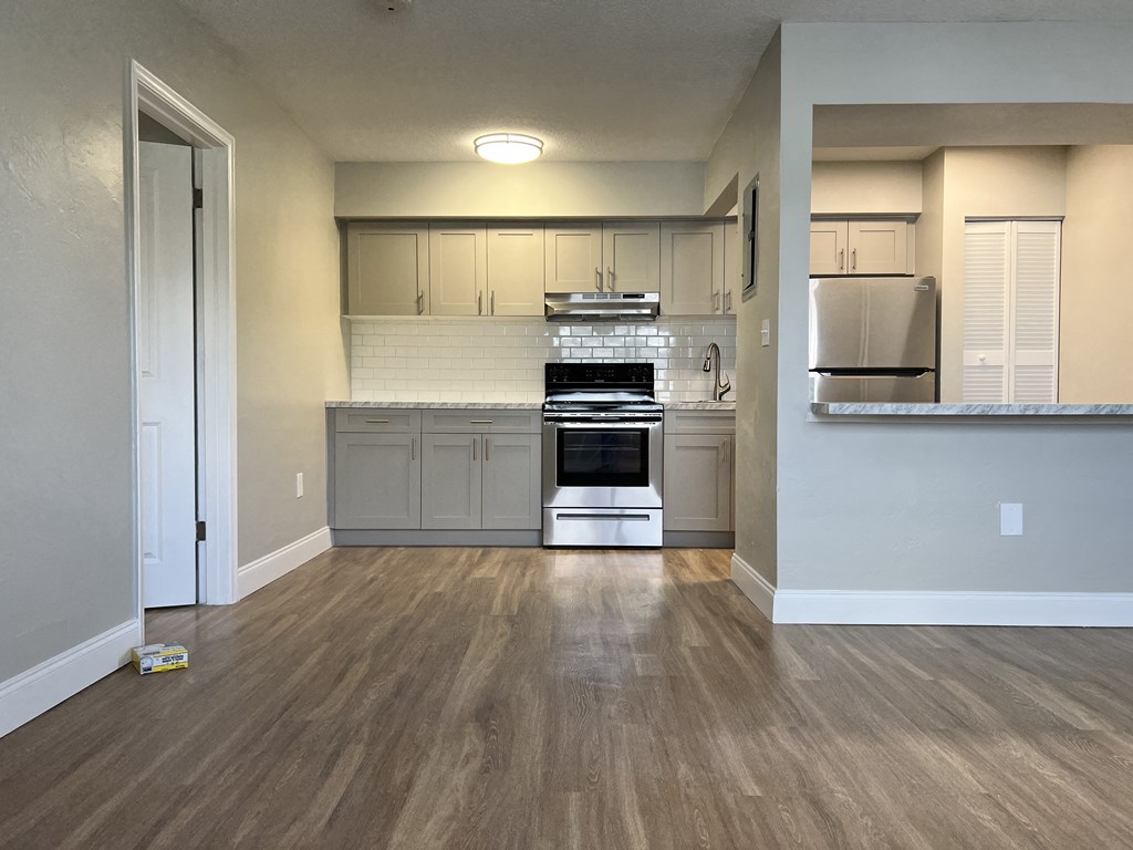 an empty kitchen with white cabinets and stainless steel appliances  at Palm Gardens @ Biscayne Gardens, North Miami, FL, 33181