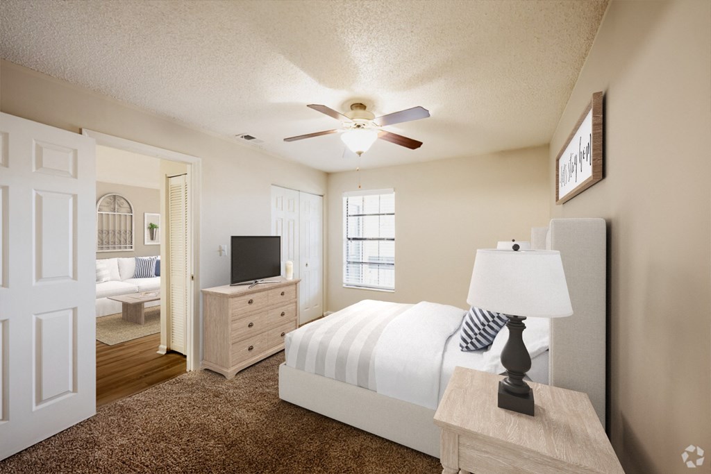 a bedroom with a white bed and a ceiling fan a bedroom with a white bed and a ceiling fan at Lakeside Gardens, Florida, 32114