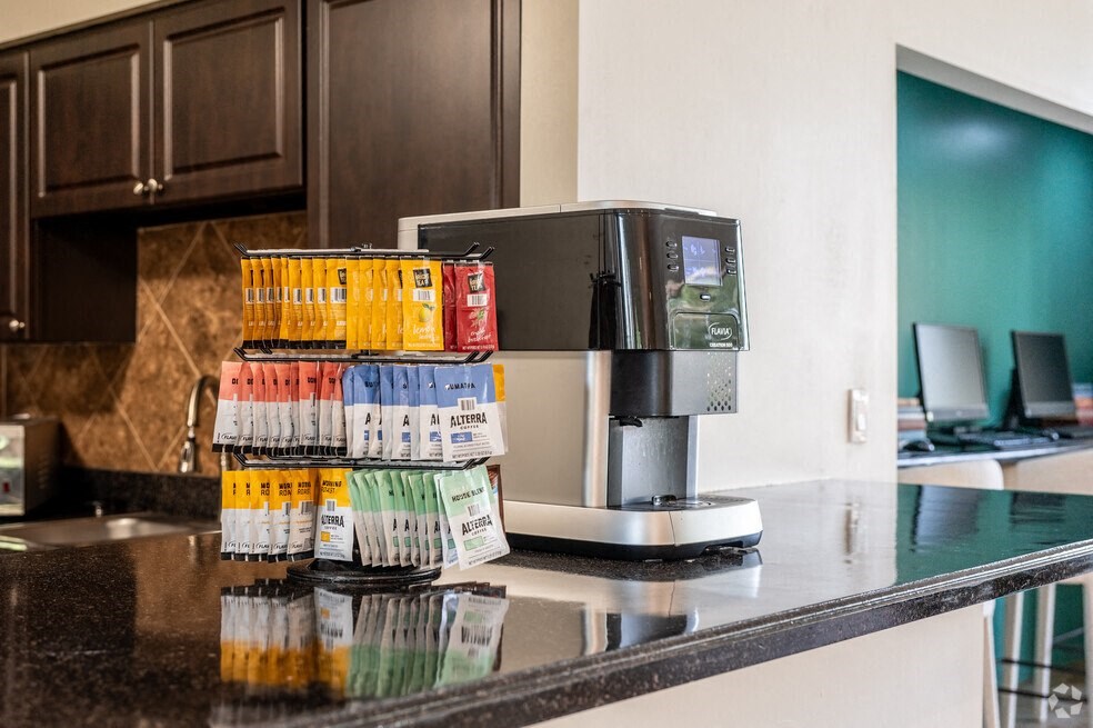 a kitchen counter with a coffee maker and coffee cups on it at Lakeside Gardens, Daytona Florida