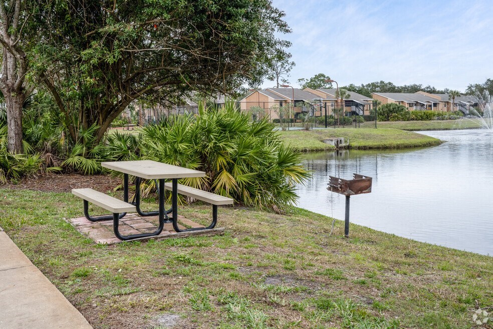 a picnic table next to a lake with a mailbox at Lakeside Gardens, Daytona, FL 32114