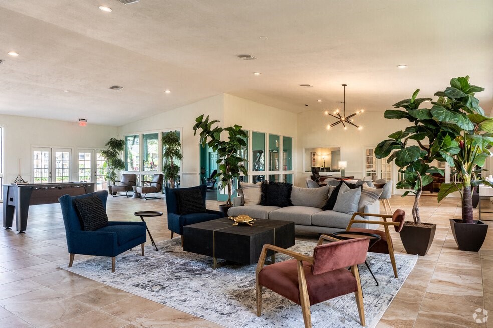 a living room with a couch and chairs and a table at Lakeside Gardens, Florida