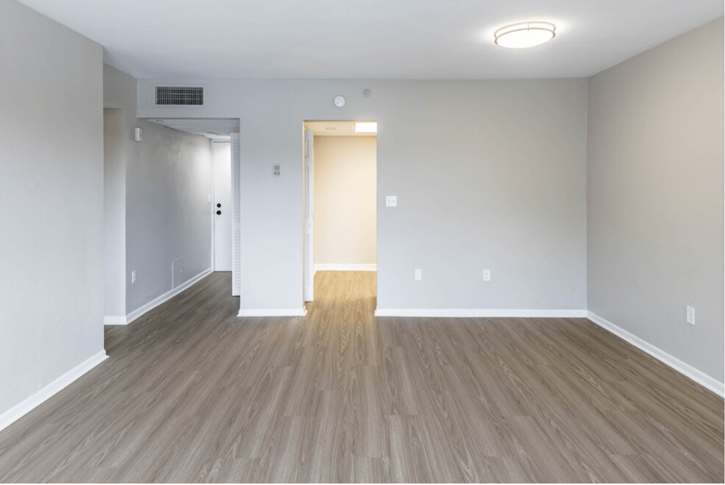 an empty living room with a hardwood floor at Lakeside @ Biscayne Gardens,North Miami, FL,33181