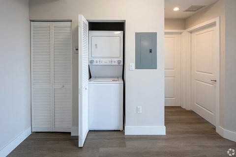 a laundry room with a washer and dryer and a closet