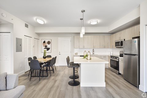 A modern kitchen with a dining table and chairs.