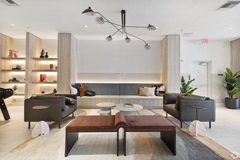 A modern living room with a grey sofa set and a wooden coffee table.