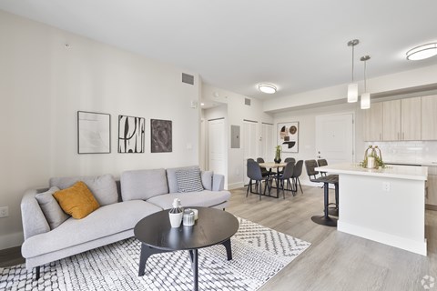 A modern living room with a grey sofa and a coffee table.