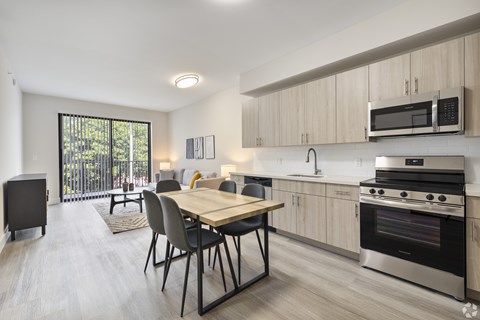 A modern kitchen with a dining table and chairs.