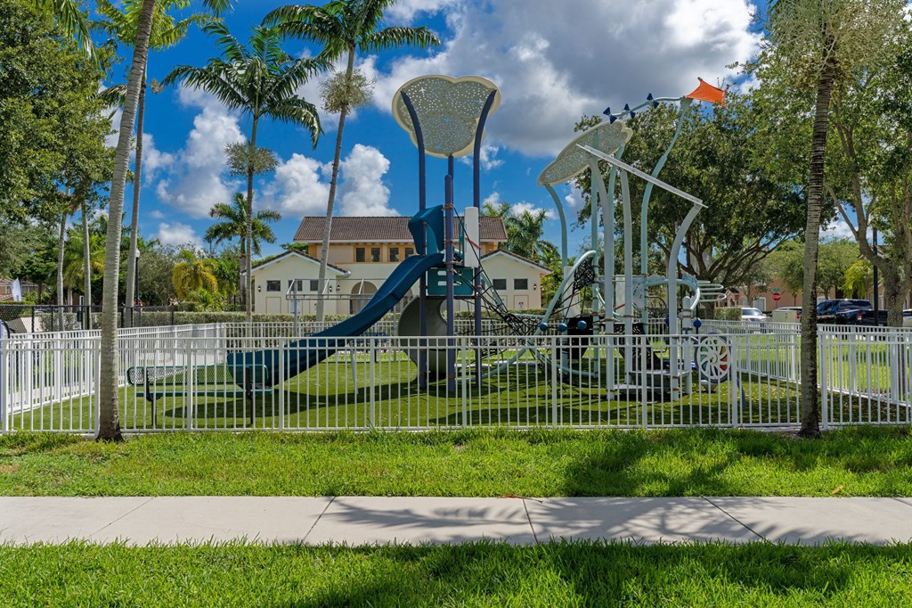 a playground at a park with a blue slide