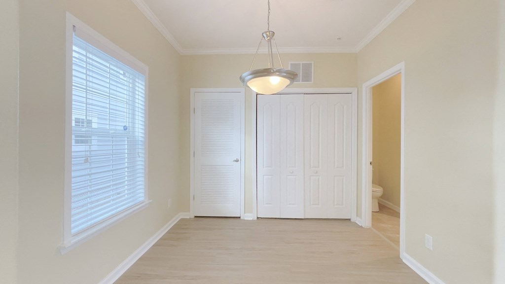 A white door is in the middle of a room.