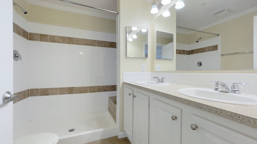 A bathroom with a white tub and sink.