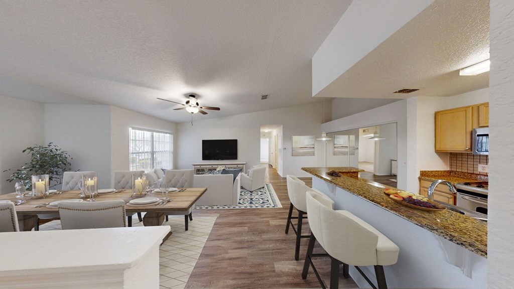a living room and dining room with a table and chairs