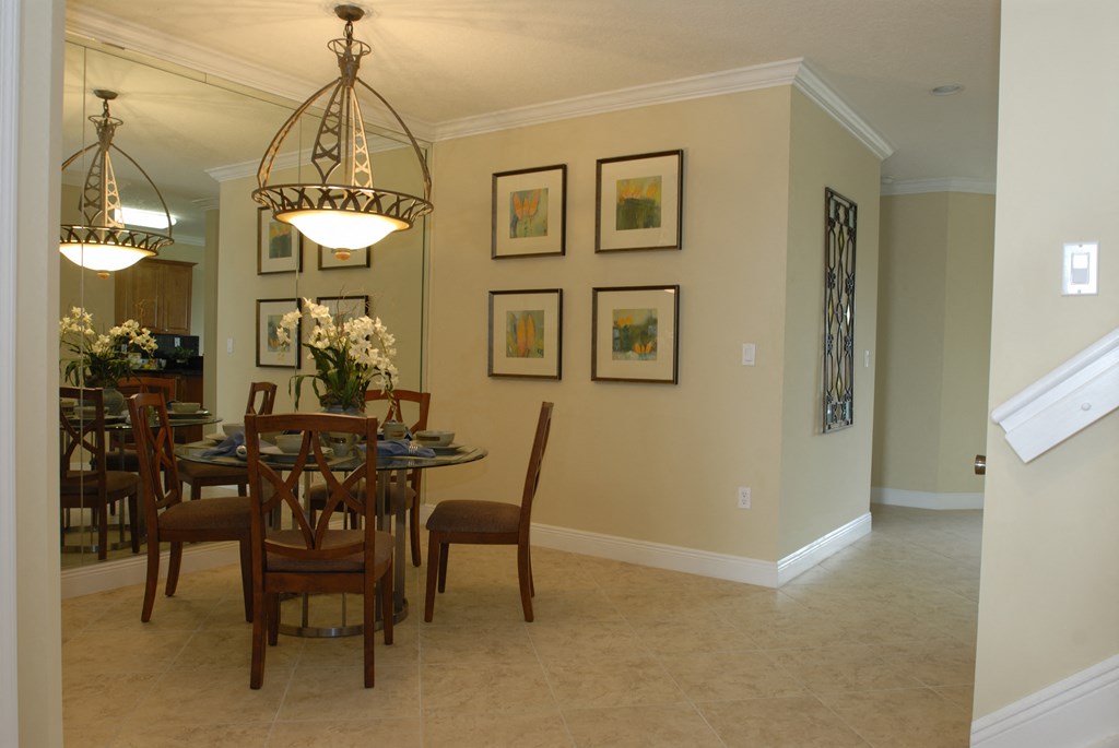 a dining room with a table and chairs and a chandelier