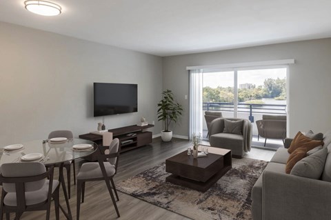 A living room with a glass table and grey chairs.