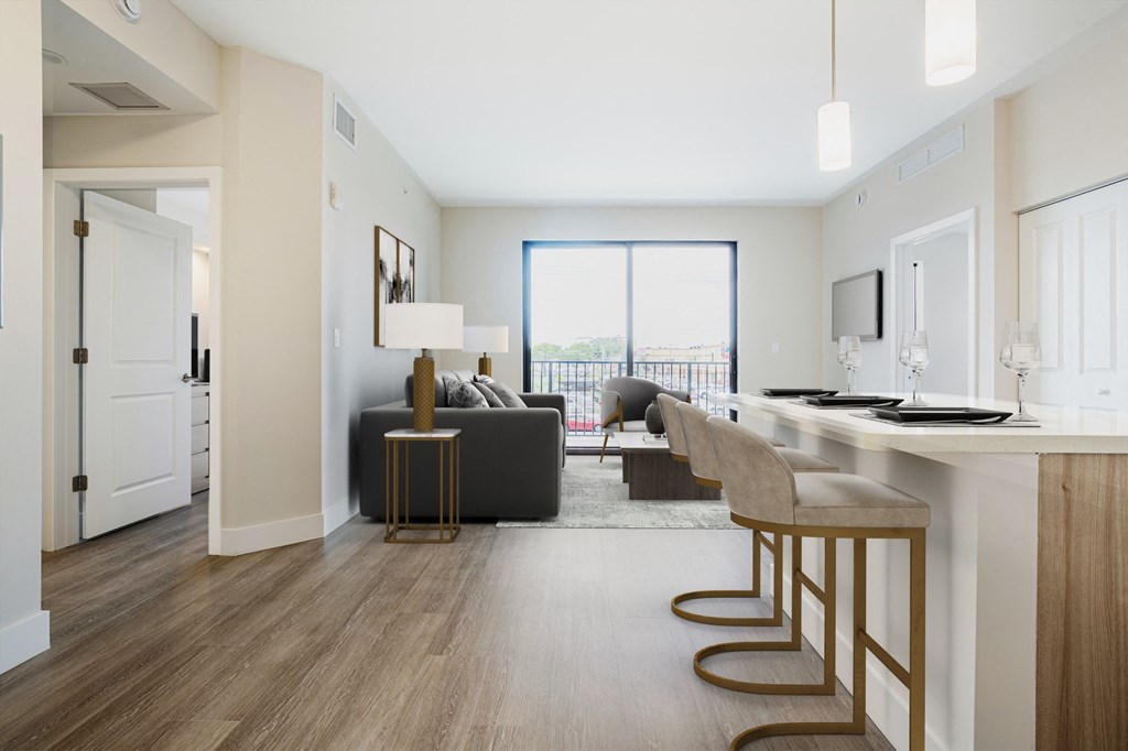 a living room with a couch and a bar and a kitchen