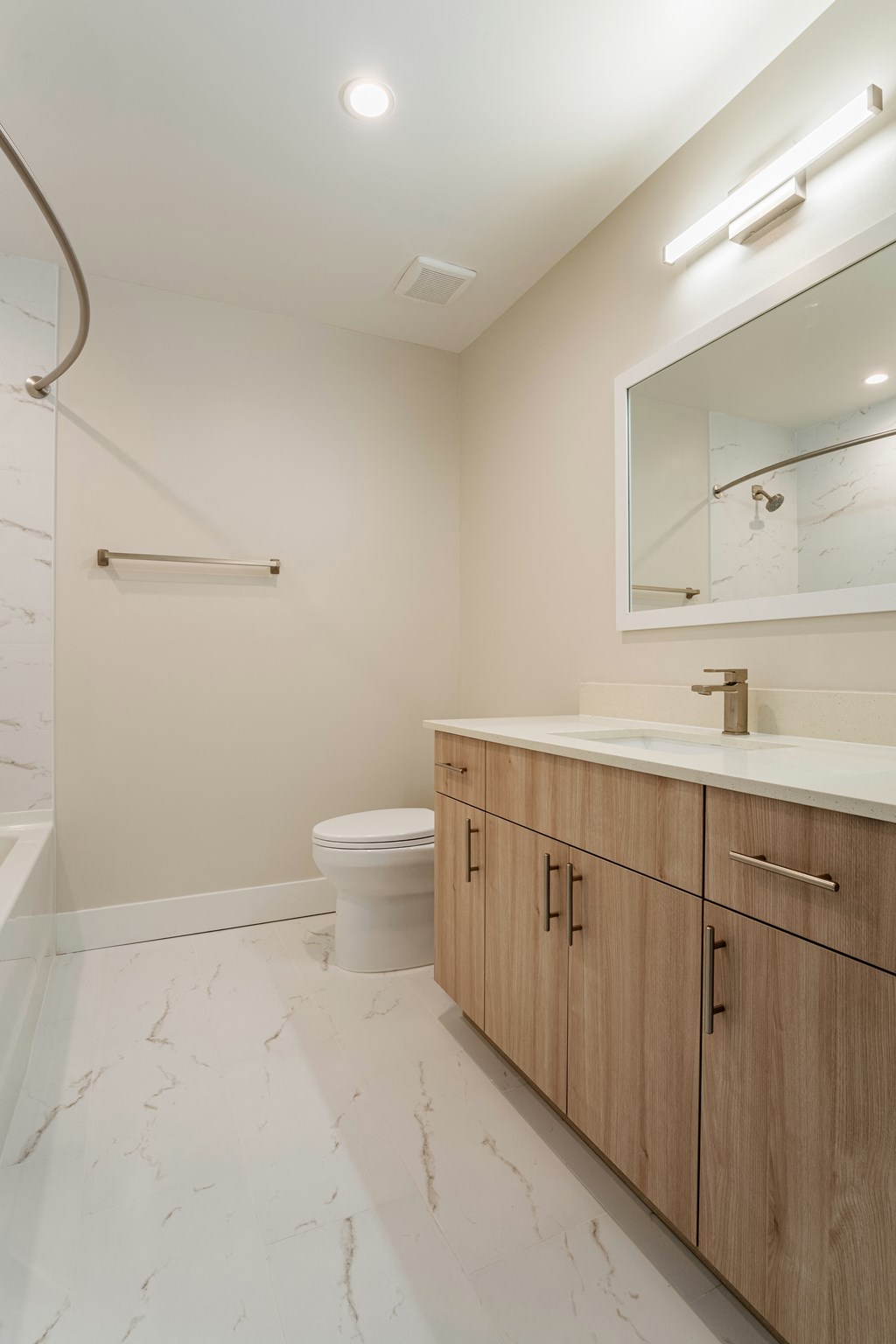 a bathroom with a toilet and a sink and a mirror