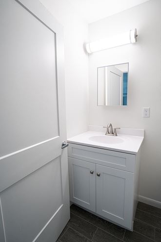 a small bathroom with a sink and a mirror