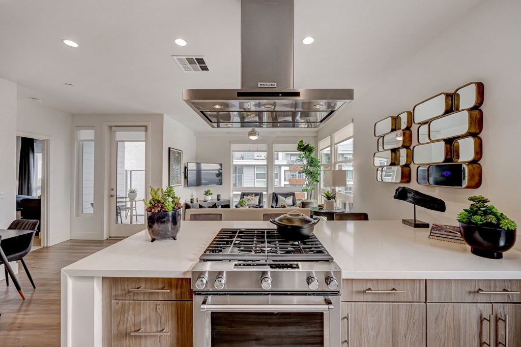 Spacious kitchen featuring a large island with a stove and microwave