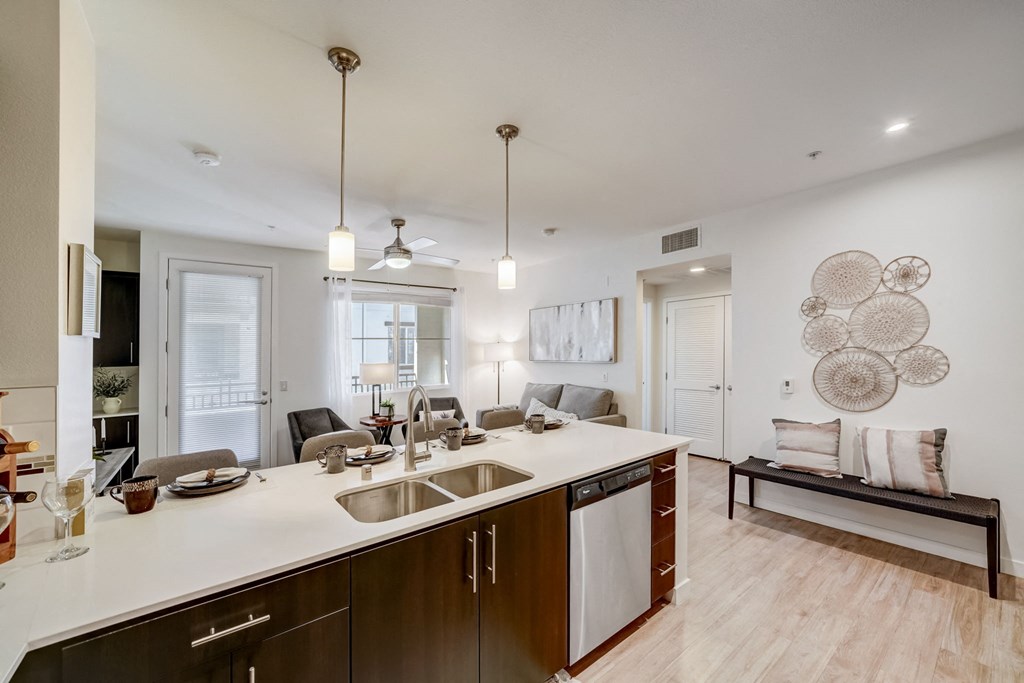 a kitchen with a large island and a living room