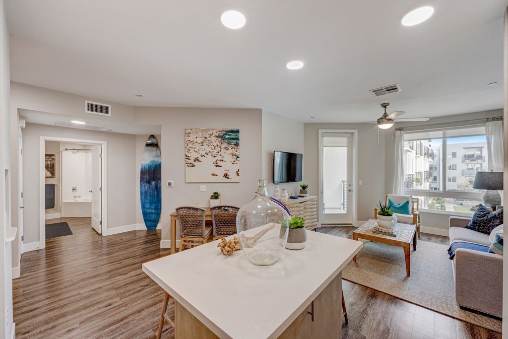 Open kitchen and living room with a white countertop.