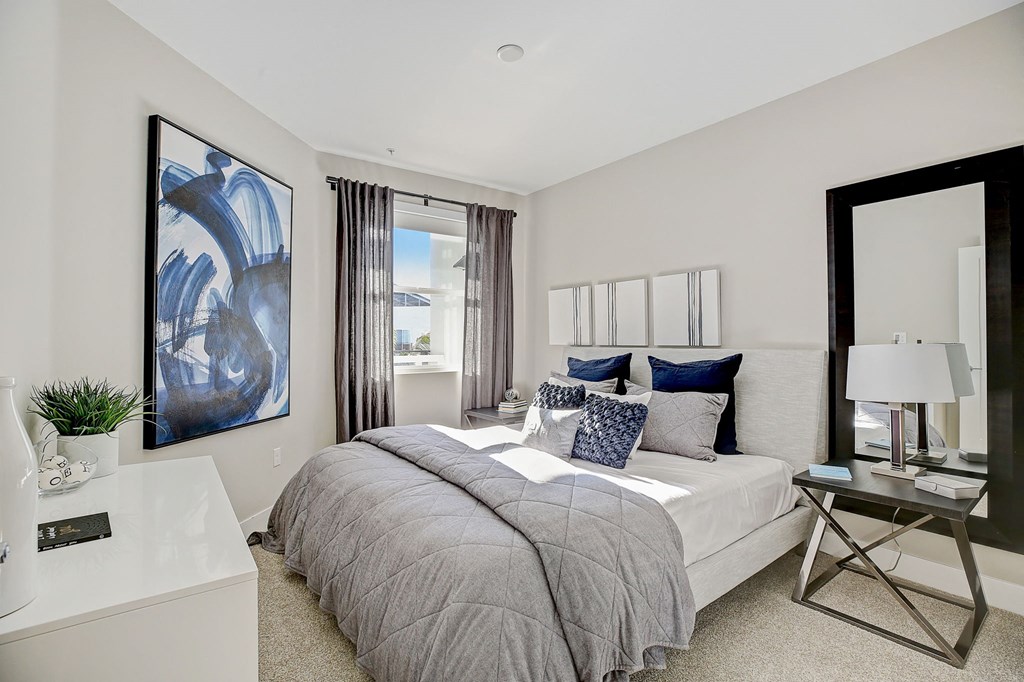 a bedroom with a bed and a mirror