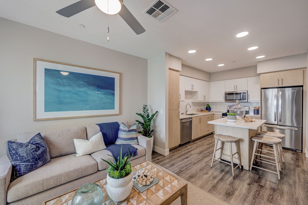 Living room and kitchen with a couch and coffee table.