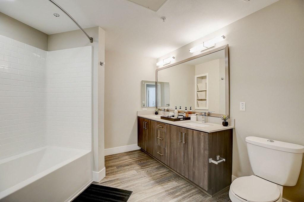 a bathroom with a large mirror and a toilet