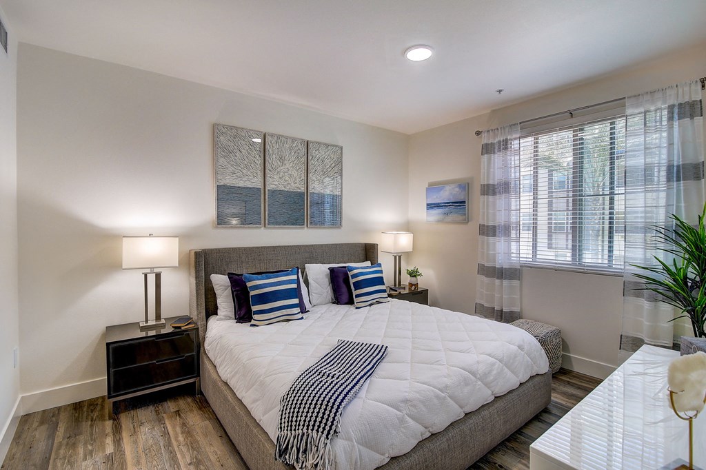 a bedroom with a large bed and a window