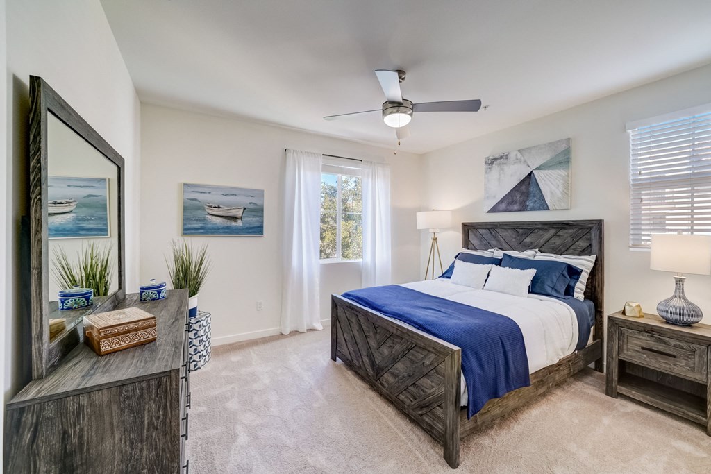 a bedroom with a large bed and a ceiling fan