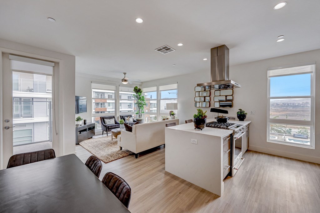 Living room with a kitchen and dining room.