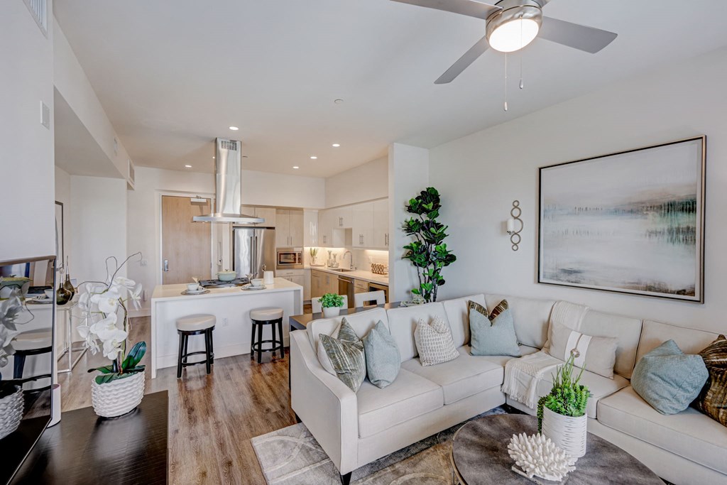 Living room and kitchen with a couch and ceiling fan