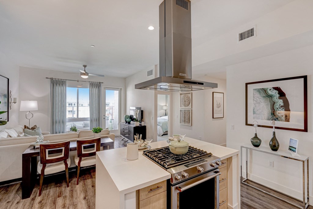 Open kitchen and dining room with large island and stovetop oven