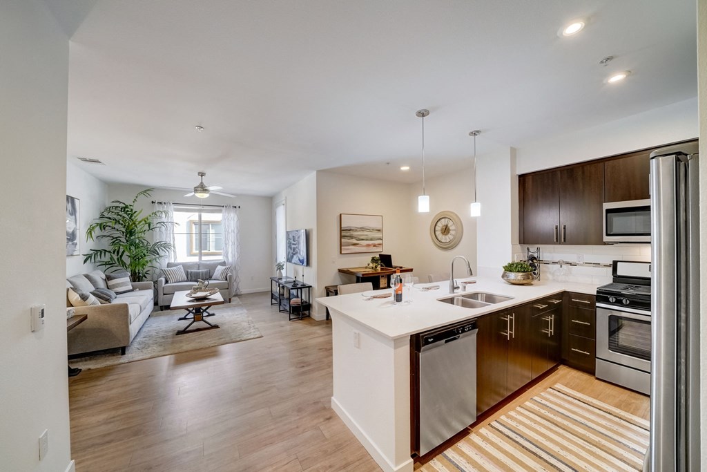 an open kitchen and living room with a couch and a table