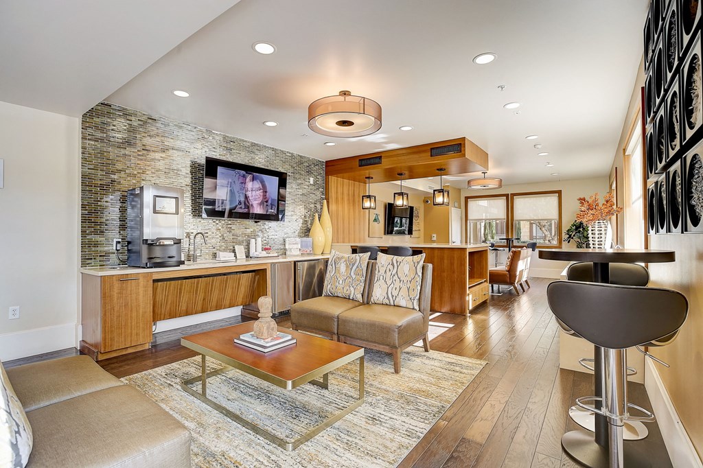 a living room with a kitchen and a table