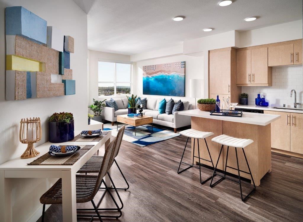 a living room and kitchen with a table and chairs