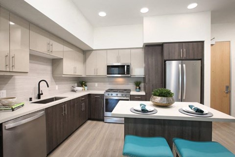 a kitchen with a table and a refrigerator